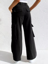 Black high-waisted wide leg cargo jeans featuring multiple pockets and a relaxed fit in durable denim material