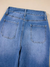 Blue denim high-waisted wide leg flare jeans with classic leg flare design and two back pockets shown from the back