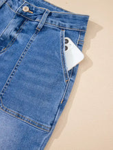 Blue denim high-waisted wide leg flare jeans with classic button closure and visible stitching for stylish wear