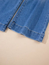 Blue denim high-waisted wide leg flare jeans with classic faded wash and visible stitching along the seams