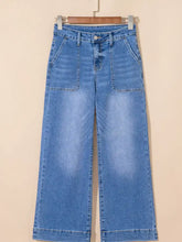 High-waisted light-wash blue denim flare jeans with wide leg flare and classic five-pocket button closure design