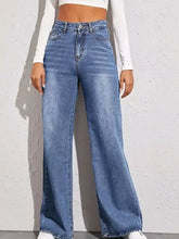 High-waisted medium-blue denim wide leg jeans with a wide leg cut and frayed hems