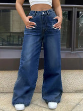 High-waisted wide leg jeans in medium blue denim with frayed hems for a stylish casual look
