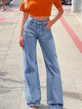 High-waisted light-wash denim wide-leg jeans with relaxed fit, slight fade, and visible stitching details