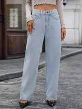 Light-wash denim high waisted wide leg jeans with a classic five-pocket design in a back view