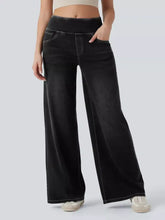 Black high-waisted wide-leg jeans with elastic waistband and white stitching in denim material
