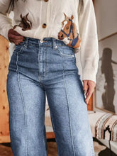 High-waisted blue denim wide leg jeans with straight-leg cut and visible stitching details fabric blend