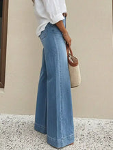 Light-wash blue denim high-waisted wide leg jeans with a classic straight-cut silhouette and rolled cuffs