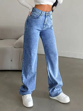 High-waisted wide leg jeans in light-wash blue denim with a relaxed, straight-cut silhouette and classic five-pocket design