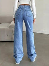 Light-wash blue denim high-waisted wide leg jeans shown from the back with classic pockets and wide leg cut