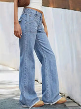 High-waisted light-wash denim wide leg jeans with frayed hems and classic five-pocket design