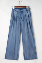 High-waisted wide-leg jeans in light-wash denim with a relaxed pleated design and button closure