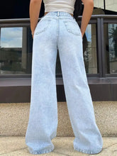 High-waisted light-wash denim wide leg jeans with a relaxed fit and classic back pockets shown from the back side