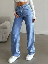 Light-wash denim high-waisted wide leg jeans with classic five-pocket design and frayed hem details