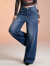 High-waisted wide leg jeans in medium blue denim with classic stitching and button closure