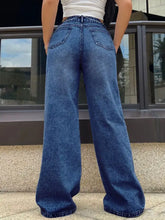 High-waisted wide leg jeans in medium blue denim with classic stitching and back pockets shown from the back side