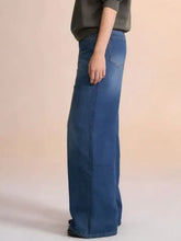 High-waisted wide leg jeans in medium blue denim with classic stitching and rear pockets shown from the back side