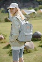 Blonde woman wearing Himawari waterproof backpack with multilayer pockets