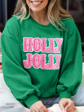 Green holly jolly towel embroidered christmas holiday sweatshirt with pink lettering, slightly stretchy, machine wash care instructions