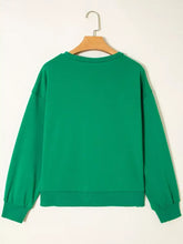 A solid emerald green holly jolly towel embroidered Christmas sweatshirt with ribbed cuffs, slightly stretchy, machine wash