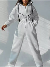 White long sleeve jumpsuit with hooded zip-up design and black accents