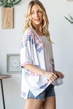 White oversized HOPELY t-shirt with scattered American flag print and bold letter graphic round neck