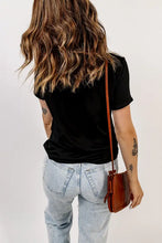 Woman in Hoppy Easter graphic tee with short sleeves, jeans and bag