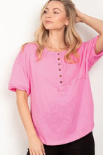 Bright pink women’s Henley shirt with half button and twisted sleeve band