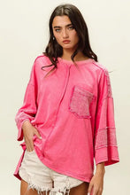 Hot pink high-low washed t-shirt with fuchsia long-sleeve top, exposed seams, and textured patch pocket for women