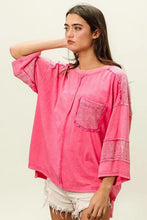 Neon pink high-low washed t-shirt with lace details and textured pocket