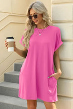 Hot pink t-shirt dress with short sleeves, relaxed fit, pockets, machine wash cold