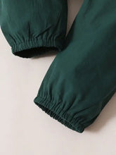 Infant ruffled collar top with full-length dark green ribbed jogger pants