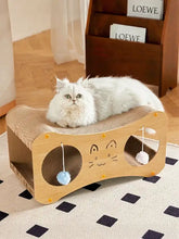 Light wood cat scratcher lounge with cat face, pom-poms and toy balls