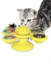 Bright yellow rotating cat toy with suction cup and spiky hub
