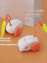 Interactive self-rotating pet teaser toy with orange wheels and yellow streamers