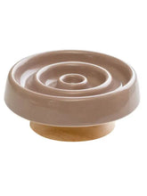 Interactive slow feeder pet bowl with beige ceramic ridges on wooden base