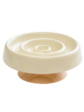 Interactive slow feeder pet bowl with cream ceramic top and wooden base
