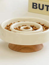 Interactive slow feeder pet bowl with cream ceramic spiral and wooden base