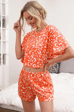Ivy lane leopard crop top and shorts set featuring an orange and white leopard print pajama set for comfortable wear
