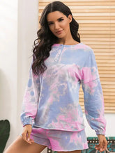 Ivy Lane tie-dye long sleeve top in pastel pink and light blue with buttoned neckline and comfortable sleeve length