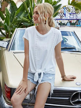 Blonde woman in Ivy Lane Tied Eyelet Round Neck Cap Sleeve T-Shirt