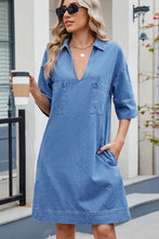 Blue denim dress with johnny collar, two front pockets, and half sleeves in a casual denim dress style