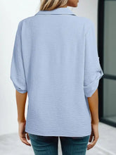 Light blue cotton johnny collar texture blouse with rolled-up three-quarter sleeves and a classic collar
