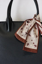 Jones PU leather handbag with brown and white horse print scarf, black handles, and spacious interior