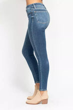 High-rise judy blue skinny jeans in blue denim with slim fit and subtle fading plus size button fly design