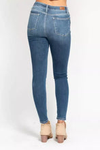 Blue denim judy blue high rise skinny jeans with five pockets and brown leather brand patch at waistband