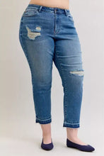 Mid-rise plus size judy blue denim jeans with distressed patches and frayed hems in medium blue wash
