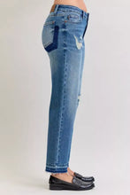Back side of judy blue plus size mid rise blue denim jeans with distressed design and dark blue pocket patch
