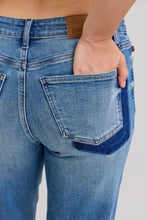 Back view of judy blue plus size mid rise blue denim jeans with dark blue patch on back pocket and brown leather tab