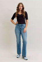 High-waisted light blue denim judy blue mid rise slim bootcut jeans with straight leg and classic five-pocket design